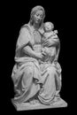 Statue of the virgin Mary carrying the baby Jesus isolated on black background. Mother of god sculpture, classic Royalty Free Stock Photo