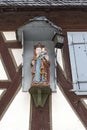 The statue of the virgin mary and jesus boys on the outer wall of an old half-timbered house Royalty Free Stock Photo