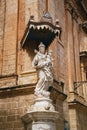 Statue Of Virgin Mary, Madonna With Jesus Child On The Corner Of Carmelite Priory In Mdina. Malta