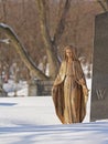 Statue of virgin mary in the snow Notre Dame des Neiges Cemetery in the snow