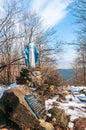 a statue of the Virgin Mary on te Ostra Mountain, Winter forest in the Carpathian Mountains, sunny day