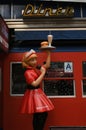 A statue of a waitress in a red uniform at a diner serving food