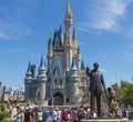 Walt Disney and Mickey mouse statue in front of Cinderella princess castle at Disney world Florida