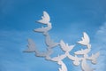 Statue of white pigeons flying on the blue sky background. Peace memorial.