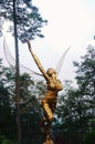 A statue of winged woman trying to fly