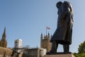 Statue of Winston Churchill in Parliament Square, London with The Houses of Parliament and the Union Jack in the background