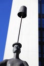 Statue of woman balancing lamp on her head