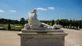 A statue of a woman in the gardens of Versailles