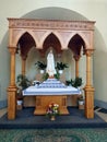 A statue of a holy woman in a long dress and a cloak covering her head.