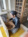 a statue of a woman making batik