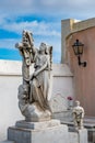 Statue of a women drapping a cross with a cloth