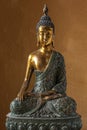 Statue of Wooden Buddha sitting in meditation on orange background Royalty Free Stock Photo