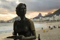 Statue of the writer Clarice Lispector with her dog `Ulisses` in the `Fishermen`s Way` with the sea in the background on the beach Royalty Free Stock Photo