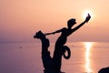 Statue of a Young Girl Holding a Shell and Riding a Seahorse Hippocampus in front of Lake Leman Vevey at Sunset