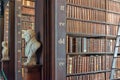 Statues and bookshelves in The Long Room in the Trinity College Old Library in Dublin Ireland