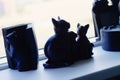 Statues of cats on a window sill