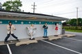 Statues of Elvis Presley, Marilyn Monroe, James Dean, and Betty Boop.