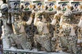 Statues at the facade of Wat Arun temple roof on a sunny day in Bangkok, Thailand Royalty Free Stock Photo