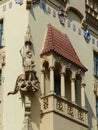 Statues of a fighter man with a death dragon in an gothic style building of Prague.