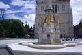 Statues of 3 golden angels on a clear sunny day