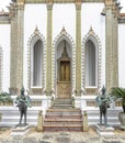 Statues of the guardian warriors at the gate of Phra Wiharn Yod Buddhist Temple in Bangkok, Thailand Royalty Free Stock Photo