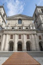 Statues of kings on the granite facade of one of the entrances to the El Escorial Monastery in Madrid with a wooden ramp to save