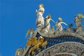Statues of lion, angels and Jesus Christ decorating upper facade of the Saint Mark`s Basilica in Venice, Italy. Royalty Free Stock Photo