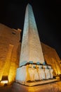 Statues and obelisk at entrance to Luxor Temple during night Royalty Free Stock Photo