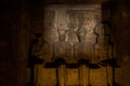 Statues of Ptah, Amun Ra, king Ramesses II and Ra-Horakhty illuminated by the rays of the sun in the Great Temple of Royalty Free Stock Photo