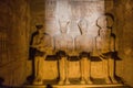 Statues of Ptah, Amun Ra, king Ramesses II and Ra-Horakhty illuminated by the rays of the sun in the Great Temple of Royalty Free Stock Photo