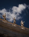 Statues of Saints and Martyrs in Saint Peter's Square under blue cloudy sky in Vatican City Royalty Free Stock Photo