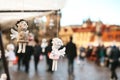 Statues Souvenirs in the form of an angel hanging on the background of Prague. a blurry crowd of people