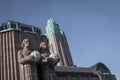 Statues of the train station in Helsinki against the blue sky