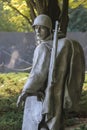 Statue of a soldier in the Korean War Veteran's Memorial. The mural wall is in the background.