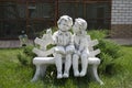 Statuette of a boy and a girl on a bench
