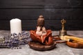 Statuette of Buddha incense sticks at workplace. Candlestick for incense. Royalty Free Stock Photo