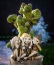 Statuette of elves not hearing not seeing not talking near the cactus