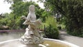 Statuette of a mermaid in a fountain with fog. Figurine of a mermaid holding two swans