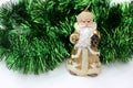 Statuette of Santa Claus on a green background. Golden santa claus candle isolated on white. Saint Nicholas in beige color with a Royalty Free Stock Photo