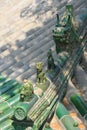 Statuettes of fantastic animals decorate the ridgepole of the roof of a temple in Beijing (China)