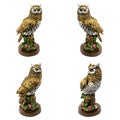 Statuettes of gold owls with flowers isolated on a white background