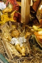 Statuettes of Mary, Joseph and the newborn baby Jesus in the hay, A Christmas crib Royalty Free Stock Photo