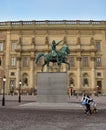 Stature of a rider and chimney sweeps running past Royalty Free Stock Photo