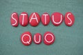Status Quo, Latin phrase composed with red colored stone letters over green sand