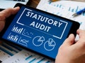 Statutory audit report on the tablet. Auditor inspect data. Royalty Free Stock Photo