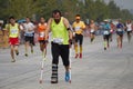 Staunch Man Racing with broken legs in marathon Royalty Free Stock Photo