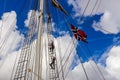 STAVANGER, NORWAY - CIRCA SEPTEMBER 2016: Three crew members climb up a Norwegian ship`s mast