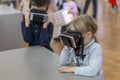 STAVROPOL, RUSSIA - APRIL 6, 2019 - Children having fun with virtual reality headsets in robot museum