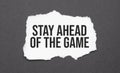 Stay Ahead of The Game sign on the torn paper on the black background