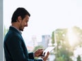 Stay ahead of the game with the smartest technology. a young businessman using a digital tablet in an office.